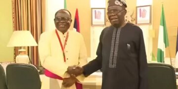 President Bola Ahmed Tinubu shaking hands with Catholic Bishop of Sokoto Diocese, Rev. Matthew Hassan Kukah