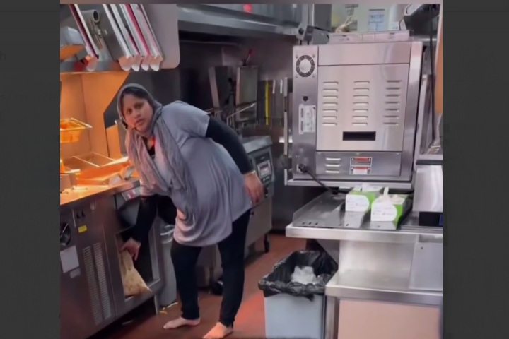 Somali national fired after a customer filmed her working barefoot behind the counter