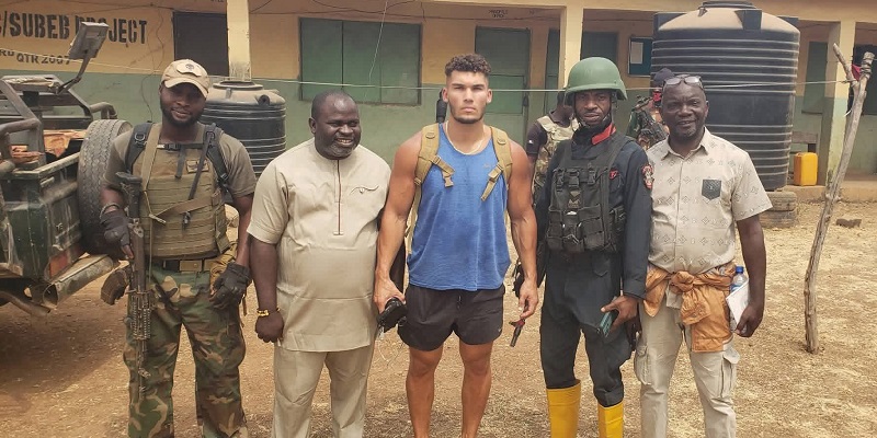 Alex Babir flanked by security personnel