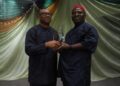 Peter Obi presenting award of excellence to Obunike Ohaegbu