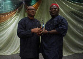 Peter Obi presenting award of excellence to Obunike Ohaegbu
