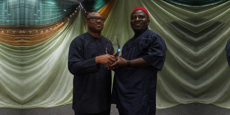 Peter Obi presenting award of excellence to Obunike Ohaegbu
