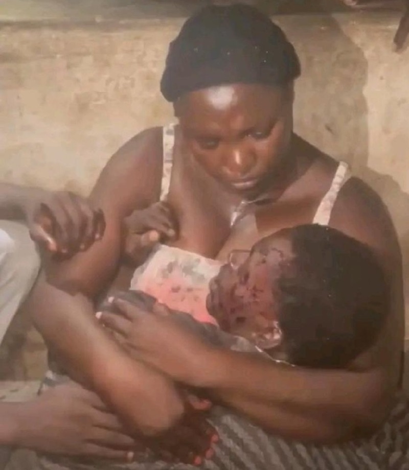 A grieving mother holds her murdered son for the last time as Jos bleeds