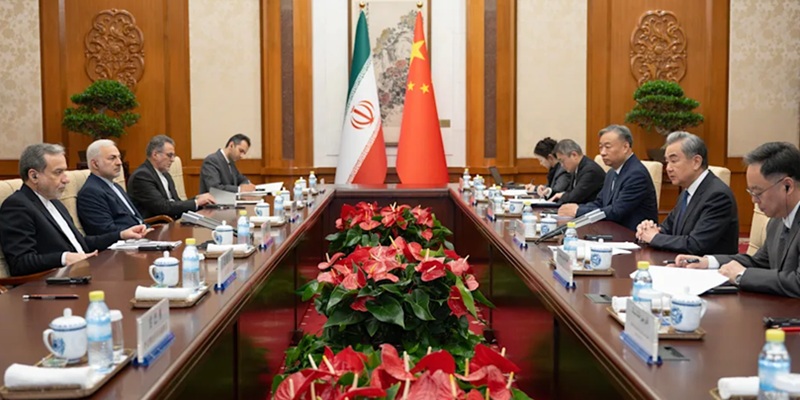 Chinese Foreign Minister Wang Yi, second right, talks to his Iranian Counterpart Abbas Araghchi, left, during the bilateral meeting in Beijing, Wednesday, May 6, 2026