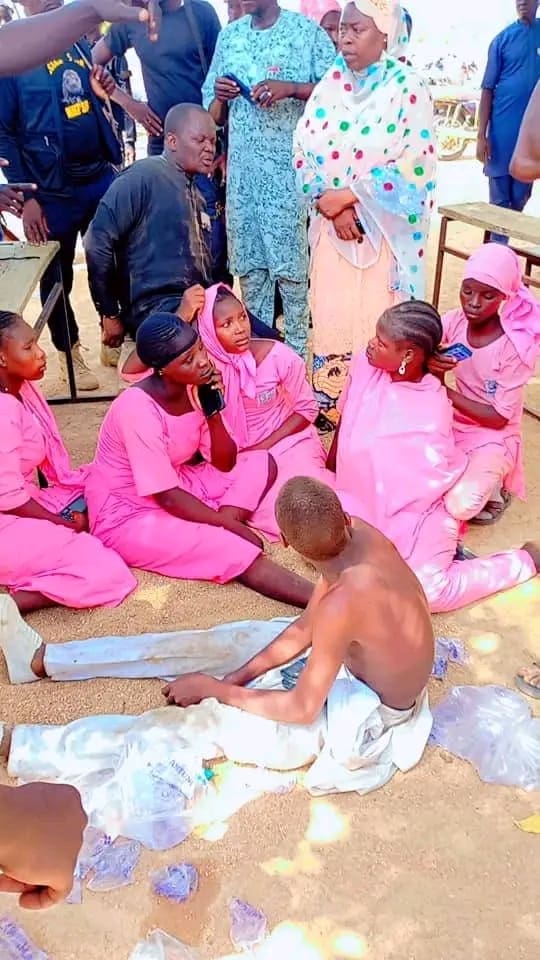 5 female students in pink color school uniform, a male student without a top among them, and man in a dark long gown identified as a teacher after escaping from Boko Haram terrorists who attacked their School, Government Day Secondary School Lassa, Uba Askira county, Borno state and a market in the town on Monday, June 29, 2026 at Lassa