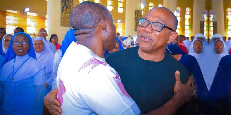 Peter Obi, who said he and his wife are godparents to Governor Charles Chukwuma Soludo's children, embracing him at an event