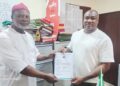 Dr. Roy Chinweuba (left) receiving certificate of return as the President General of Abba Town Union on Anambra State